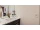 Bathroom with a modern black vanity, white countertop, decorative mirror and hardware at 1217 E 26Th Ave, Denver, CO 80205