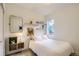 Bright bedroom with neutral decor features floating shelves and a full-sized bed at 1217 E 26Th Ave, Denver, CO 80205