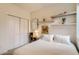 Neutral bedroom features a storage cabinet, floating shelves, and white bi-fold closet at 1217 E 26Th Ave, Denver, CO 80205