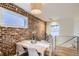 Charming dining area with exposed brick wall, modern table setting, and natural light at 1217 E 26Th Ave, Denver, CO 80205