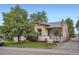 Quaint home featuring well-maintained landscaping, a brick facade, and street-side appeal at 1217 E 26Th Ave, Denver, CO 80205