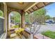 Inviting front porch featuring a yellow table set, brick archway, and neighborhood view at 1217 E 26Th Ave, Denver, CO 80205