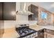 Well-equipped kitchen featuring stainless steel range, exposed brick, and light countertops at 1217 E 26Th Ave, Denver, CO 80205