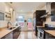 Contemporary kitchen featuring stainless steel appliances, quartz countertops, and modern lighting at 1217 E 26Th Ave, Denver, CO 80205