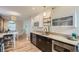Stylish kitchen with stainless steel appliances, black lower cabinets, and modern fixtures at 1217 E 26Th Ave, Denver, CO 80205