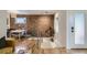 Open-concept living area with exposed brick, dining space, and seamless flow to other rooms at 1217 E 26Th Ave, Denver, CO 80205