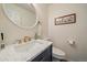Stylish half bathroom with modern fixtures, a decorative mirror, and tasteful decor at 4720 S Dudley St # 44, Littleton, CO 80123