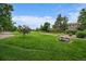 Expansive community green space features picnic benches and mature trees at 4720 S Dudley St # 44, Littleton, CO 80123