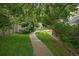 Lush community green space with a sidewalk path leading through foliage at 4720 S Dudley St # 44, Littleton, CO 80123