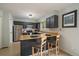 Functional kitchen with stainless steel appliances, tiled floors, and breakfast bar seating at 4720 S Dudley St # 44, Littleton, CO 80123