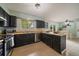 Eat in kitchen featuring stainless steel appliances, black cabinets, and hardwood floors at 4720 S Dudley St # 44, Littleton, CO 80123