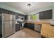 Well-equipped kitchen featuring stainless steel appliances, black cabinets, and plenty of counter space at 4720 S Dudley St # 44, Littleton, CO 80123