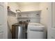 Laundry room features a washer, dryer, and shelving at 4720 S Dudley St # 44, Littleton, CO 80123