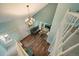 Open living room boasts hardwood floors, high ceilings, and modern chandelier lighting at 4720 S Dudley St # 44, Littleton, CO 80123