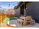 A backyard featuring a wood table with chairs, wood fence and artificial grass at 2777 Ironton St, Denver, CO 80238
