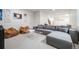 Basement featuring carpet floors, couches, clear coffee table, and stylish decorations at 2777 Ironton St, Denver, CO 80238