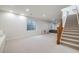 Spacious basement with carpet floors, stairs and windows for plenty of natural light at 2777 Ironton St, Denver, CO 80238