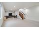 Basement with carpet floors, stairs, TV and comfortable gray couches at 2777 Ironton St, Denver, CO 80238