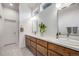 Bright bathroom featuring double vanity with wood cabinets, white countertop and tiled floors at 2777 Ironton St, Denver, CO 80238