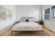A bedroom featuring a bed, side tables, a plant and tapestries at 2777 Ironton St, Denver, CO 80238