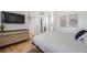 Bedroom featuring a bed, a wooden dresser with a tv and a mirror at 2777 Ironton St, Denver, CO 80238