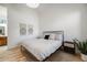 A bedroom featuring a bed, side tables, a plant and tapestries at 2777 Ironton St, Denver, CO 80238