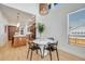 Modern dining area with hardwood floors, stylish pendant lighting, and views into the kitchen and living spaces at 2777 Ironton St, Denver, CO 80238