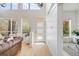 Bright foyer with soaring ceilings, hardwood floors, large windows, and a modern three panel front door at 2777 Ironton St, Denver, CO 80238