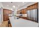 Modern kitchen featuring wooden cabinets, stainless steel appliances, and a large island with a white countertop at 2777 Ironton St, Denver, CO 80238