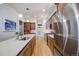 Spacious kitchen with stainless steel appliances, wood cabinets, and an island with a sink, offering a modern design at 2777 Ironton St, Denver, CO 80238