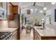 Bright, modern kitchen with wooden cabinets, stainless steel appliances, and open views to living and dining areas at 2777 Ironton St, Denver, CO 80238