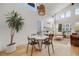 Open concept living and dining area with hardwood floors, vaulted ceilings, and plenty of natural light at 2777 Ironton St, Denver, CO 80238