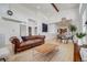 Open concept living and dining area featuring hardwood floors, high ceilings, and seamless flow at 2777 Ironton St, Denver, CO 80238