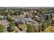 Lush aerial view of a home with a pool nestled among mature trees at 9505 Poundstone Pl, Greenwood Village, CO 80111