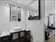 This modern bathroom boasts dual sinks, sleek cabinetry, and contemporary fixtures at 9505 Poundstone Pl, Greenwood Village, CO 80111