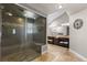 Spacious bathroom with a large glass shower, travertine flooring, and stylish and vanities at 9505 Poundstone Pl, Greenwood Village, CO 80111