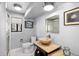 Modern bathroom with a wooden vessel sink, shower, and neutral wall color at 9505 Poundstone Pl, Greenwood Village, CO 80111