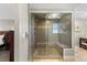 Modern bathroom featuring a glass-enclosed shower with dual showerheads and stone flooring accents at 9505 Poundstone Pl, Greenwood Village, CO 80111