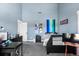 Bedroom with blue walls, a dark bed, and multiple decor items at 9505 Poundstone Pl, Greenwood Village, CO 80111