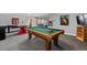 Spacious game room featuring a pool table and vintage arcade game at 9505 Poundstone Pl, Greenwood Village, CO 80111