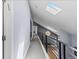 Upper level hallway with modern railings and an overhead skylight at 9505 Poundstone Pl, Greenwood Village, CO 80111