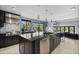 Gourmet kitchen with island, modern appliances, and a view to the outside at 9505 Poundstone Pl, Greenwood Village, CO 80111