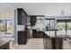 Modern kitchen with dark cabinets, granite countertops, stainless steel appliances, and ample counter space at 9505 Poundstone Pl, Greenwood Village, CO 80111