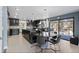 Eat-in kitchen featuring a large island, dining table, and access to an outdoor deck at 9505 Poundstone Pl, Greenwood Village, CO 80111