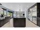 Open kitchen with large island, stainless appliances, and plenty of natural light at 9505 Poundstone Pl, Greenwood Village, CO 80111