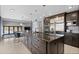 Beautiful kitchen island featuring dark wood cabinetry, stainless appliances, and barstool seating at 9505 Poundstone Pl, Greenwood Village, CO 80111