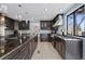 Spacious kitchen with dark cabinets, modern appliances, and granite countertops at 9505 Poundstone Pl, Greenwood Village, CO 80111