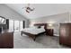 Spacious main bedroom with vaulted ceilings, plush carpet, and a private balcony at 9505 Poundstone Pl, Greenwood Village, CO 80111