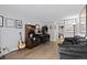 Comfortable office with hardwood floors, built-in shelves, and a cozy sitting area at 9505 Poundstone Pl, Greenwood Village, CO 80111