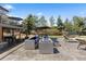 This spacious patio boasts ample seating, a fire pit, and lush landscaping, perfect for outdoor entertaining at 9505 Poundstone Pl, Greenwood Village, CO 80111
